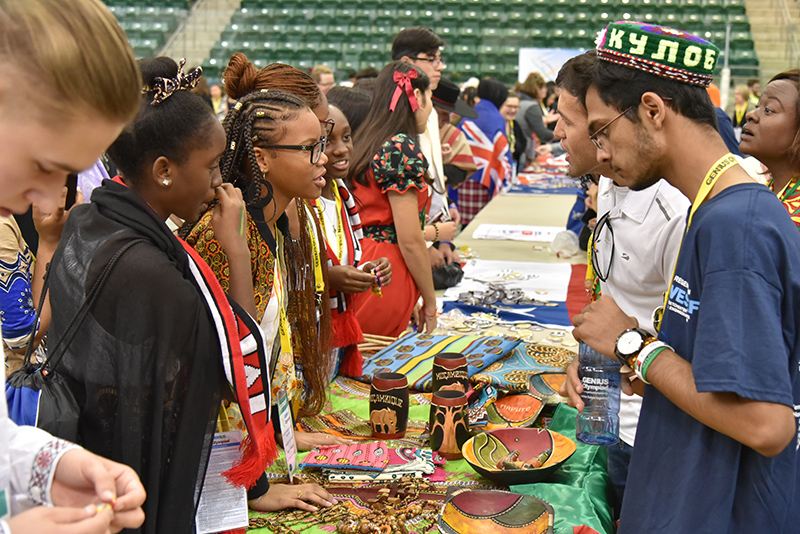 Students from Mozambique host a table at the GENIUS Olympiad International Fair