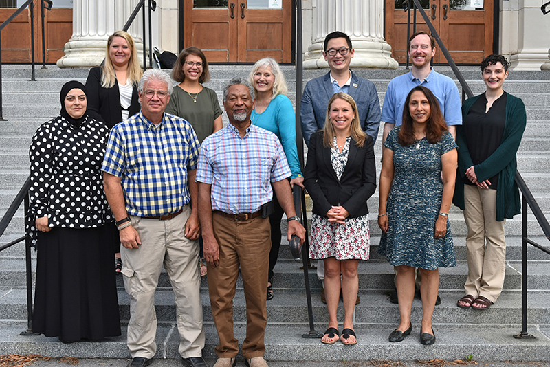 New faculty pose on the steps of Sheldon Hall