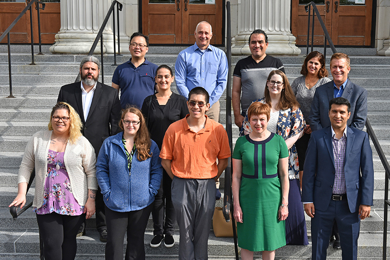 New faculty pose on the steps of Sheldon Hall