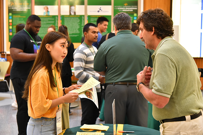 Steve Smith from the Writing Center talks with student Yoo Rim Kim from South Korea during International Student Orientation