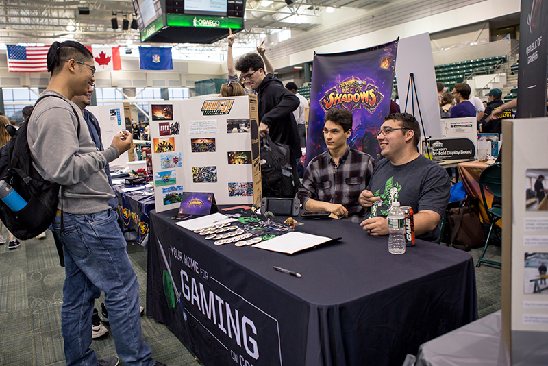 Student Involvement Fair visitors (at left) Hieu Phan and Nicholas Perry talk with E-Sports Association members (seated at table) Nicholas Ruiz and Brian Richardson