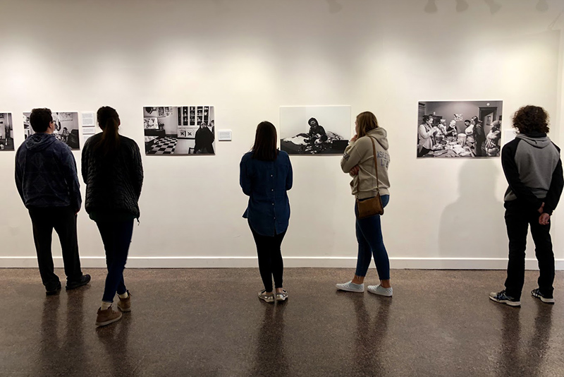 Students look at Recreating Home: Photography of the Refugee Experience exhibition