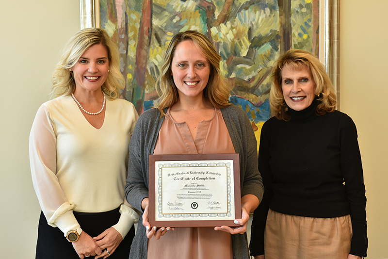 Michaela Smith (center) recently became the latest participant in the college’s Festa Graduate Leadership Fellowship; Michaela Smith (center) recently became the latest participant in the college’s Festa Graduate Leadership Fellowship. The mental health counseling student earned the $4,000 fellowship and an intensive placement at Farnham Family Services in Oswego. Dean of Graduate Studies Kristen Eichhorn and President Deborah F. Stanley congratulate Smith