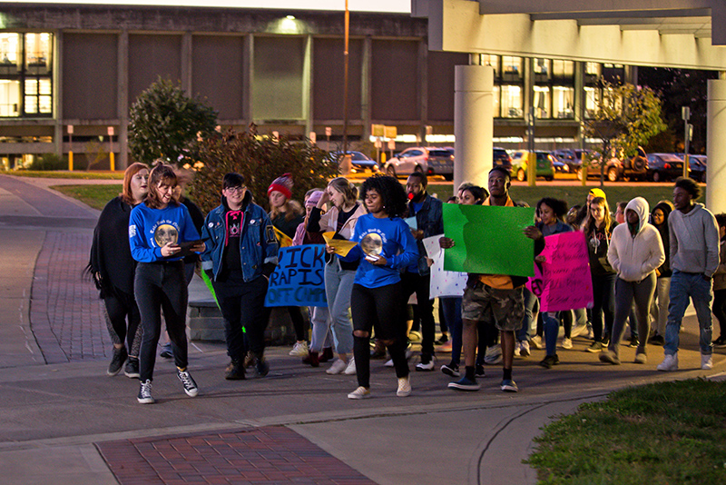 Take Back the Night participants took part in the annual event to show unity and support against sexual violence, this year on Oct. 23. Coordinated by The Women’s Center on campus, the event included sign-making, short speeches, a walk around campus and an opportunity to meet with Services to Aid Families advocates. (Photo by Megan Briggs)