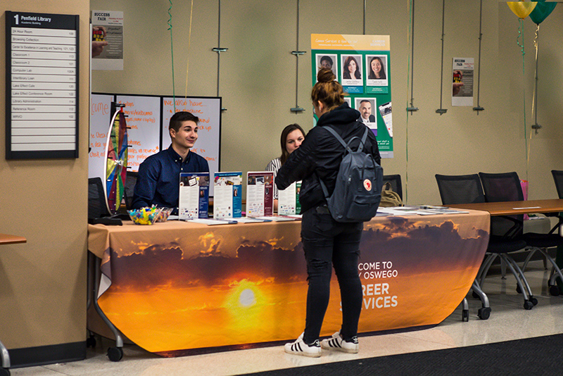 Justin McKissick and Emily Ziemba, representing Career Services, talk with students Oct 24 in the lobby during Penfield Library’s hosted Success Fair