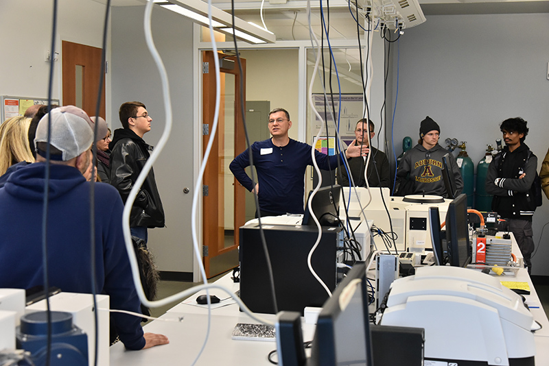 Chemistry department chair Fehmi Damkaci leads a tour group through the chemistry labs in the upper Innovations Wing of the Shineman Center during the Nov. 11 Admissions Open House.