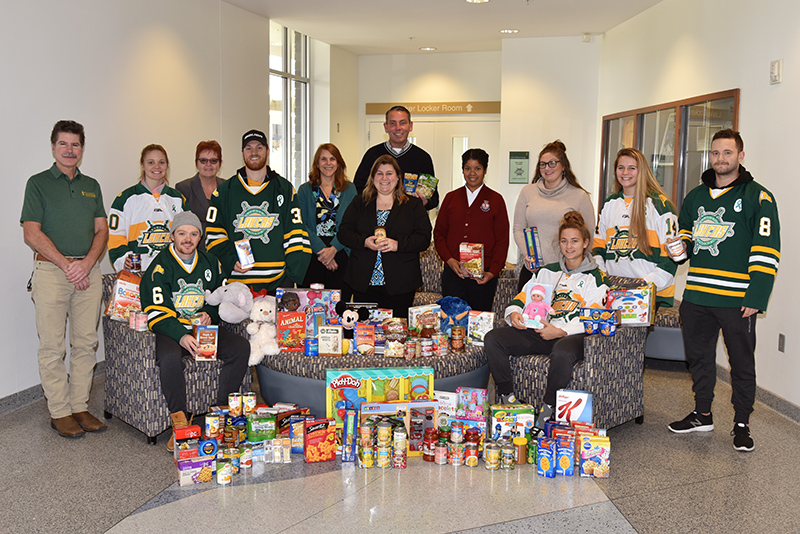 Laker hockey players, SEFA organizers, community partners with food and toy collections