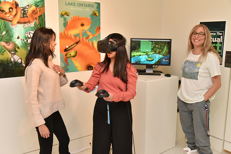 Pragya Pahari demonstrates her virtual reality project during the opening reception for the Bachelor of Fine Arts exhibition at Tyler Art Gallery