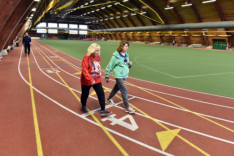 Oswego residents Daine Chesare, foreground left, Sally Clarke and other community members took advantage of the indoor track at Romney Field House during Cruisin' the Campus