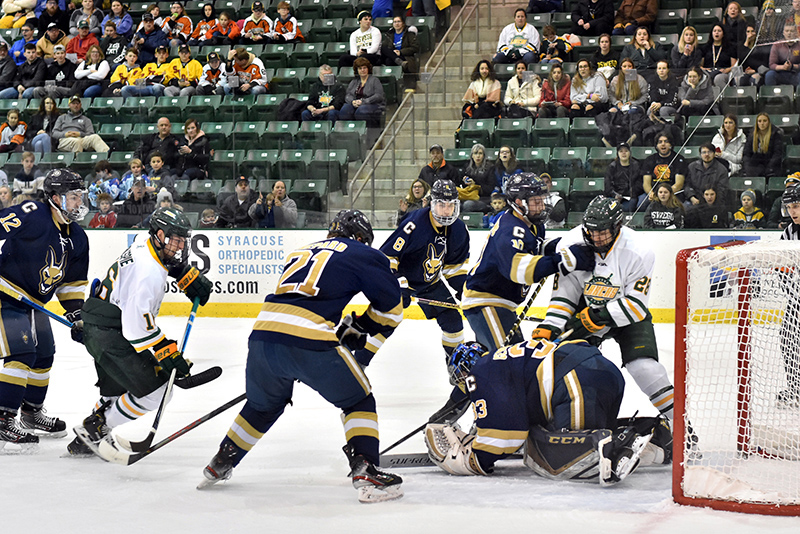 Men's hockey forwards senior Michael Gillespie (#16) and sophomore Travis Broughman (#28) pressure Canton's defense during an 8-2 win for the Lakers