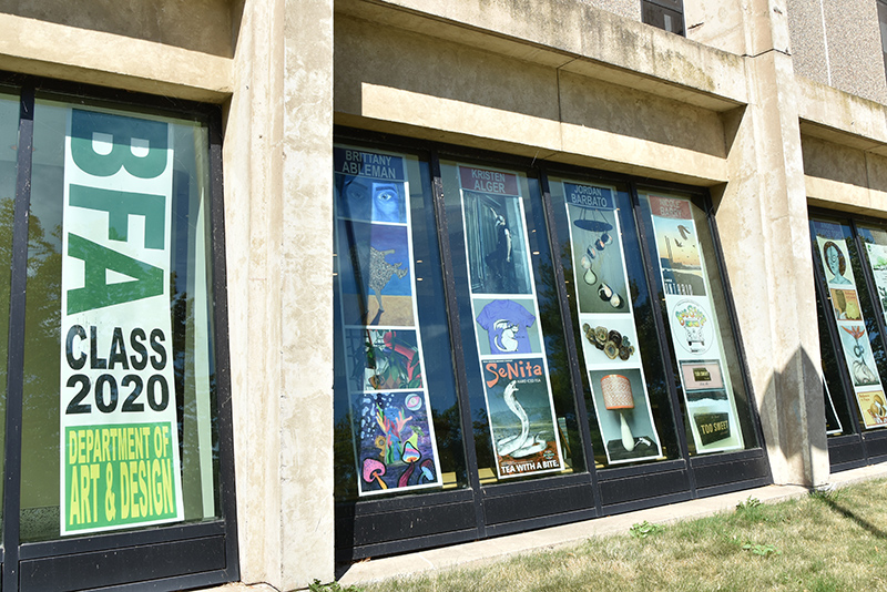 The BFA exhibition for bachelor of fine arts spring 2020 graduates appears as posters of student art lining the windows of Tyler Hall.