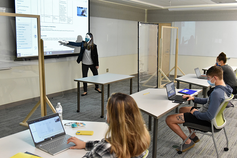 Elizabeth Keida teaches a wellness class -- complete with masks and facility features reflecting current health protocols -- in recently renovated room B5 of Wilber Hall.