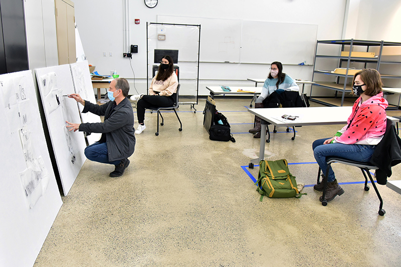 Art faculty member Richard Metzgar leads a critique of his students' experimental work during a class in 2-D design in Tyler Hall.