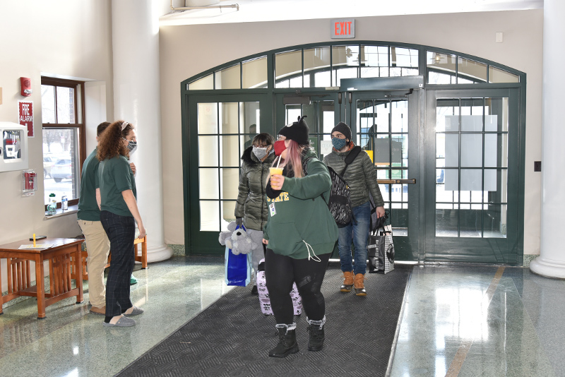 Elizabeth Maldonado enters the Johnson Hall main entrance on Jan. 24 with some family members helping her with her belongings.