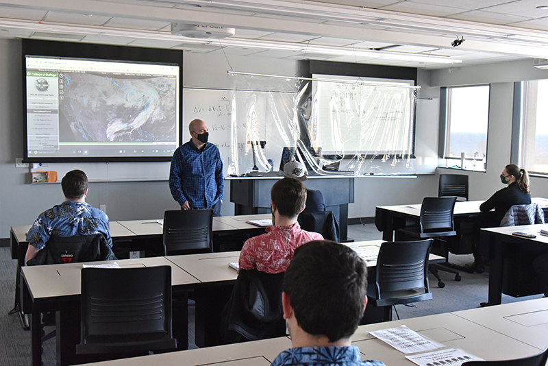 Atmospheric and geological sciences faculty member Scott Steiger teaches a meteorology class to students in the Shineman Center on Feb. 5, also the date of National Weather Person's Day