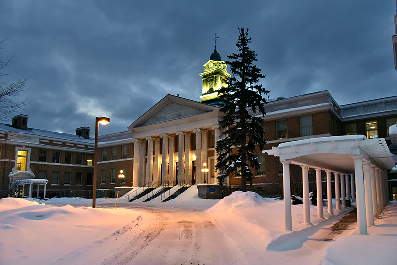 An Oswego winter evening with snow Feb. 14 reflects the aesthetic of classic architecture found in Sheldon Hall.