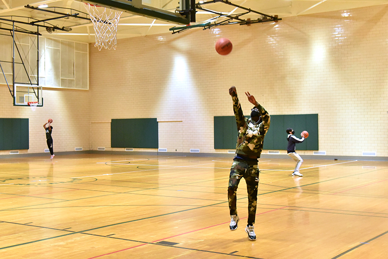 Jamal Brown, a freshman adolescence education major, advances toward the basket in Swetman Gymnasium, which Campus Recreation has open for a variety of uses in accordance with health protocols.