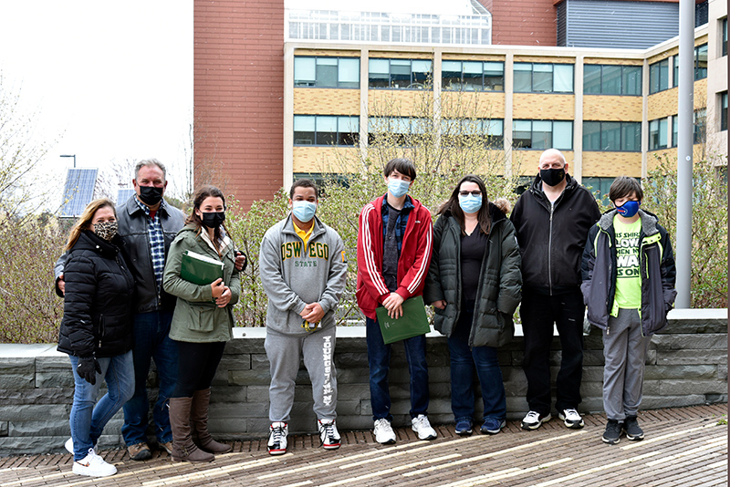 Admitted students had opportunities to tour campus in April. Pausing for a group photo April 21 outside the Shineman Center are two groups led by Admissions student tour guide Romeo Yotat (center), a junior broadcasting and mass communication major.