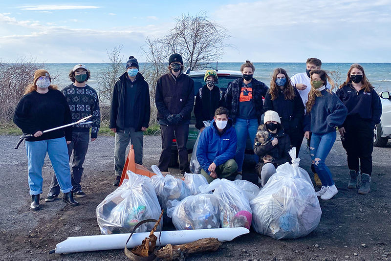 Sustainability students and volunteers are pictured April 22 with some of the litter they collected along the Lake Ontario shore during Earth Week.