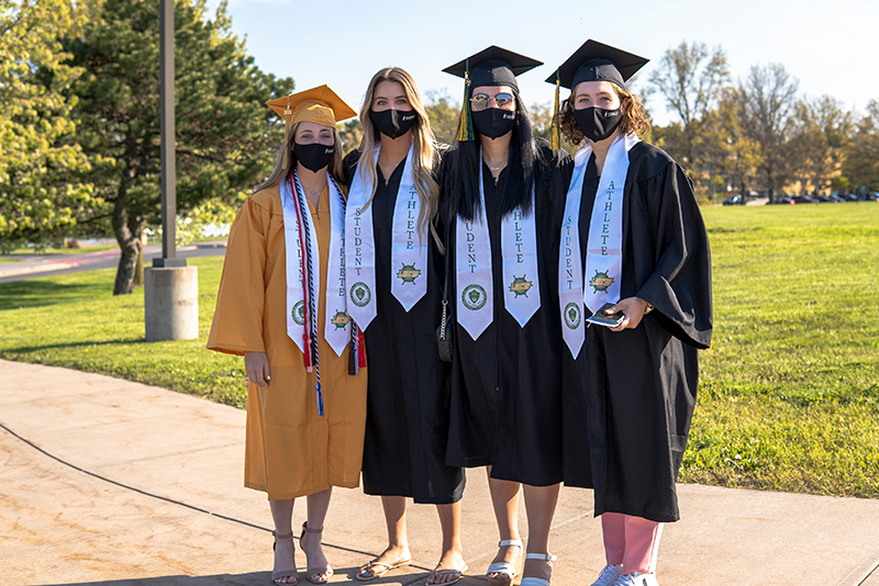 A group of student-athletes pause before the 9 a.m. Saturday, May 15, ceremony.