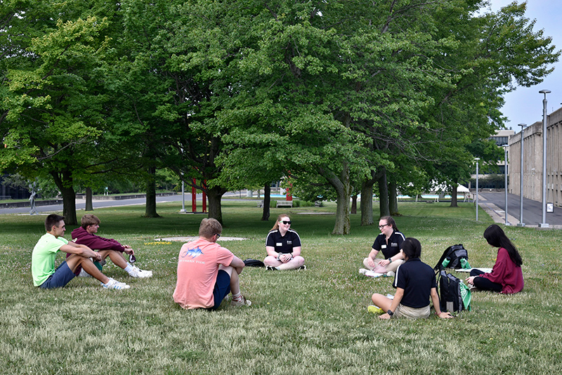 Working with a group outside Marano Campus Center on July 6 are Laker Leaders Kat McGreevy (left), Laker Leader captain Erika Horne and Kate Donaghue (back to camera).