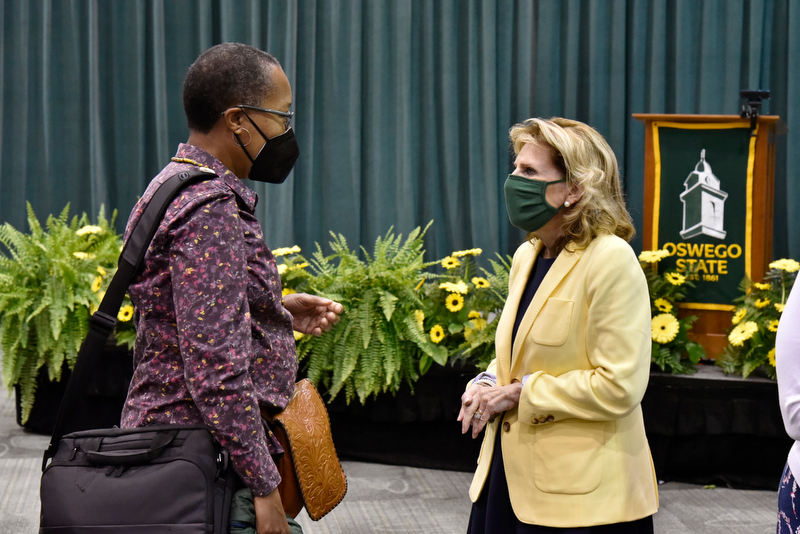 President Deborah F. Stanley (right) speaks after the Aug. 18 Fall 2021 Opening with Jennifer Shropshire, a 1986 alumna, principal for Edward F. Swenson & Associates, Inc., and a very active member of the Oswego Alumni Association Board of Directors, as well as a past board president.