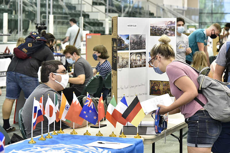 The college's Student Involvement Fair, typically held during the first week of the semester, allows students to explore some of the more than 200 clubs and organizations on campus. Pictured Aug. 25 in the Marano Campus Center arena is History Club member Joseph Falkowski (seated left) talking with Gabrielle Montalbano.