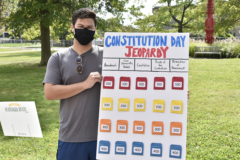 Dylan Lefton, a senior human development major and community services intern, helped to celebrate national United States Constitution Day on Sept. 17 by hosting a table outside Penfield Library offering information and related quiz games.