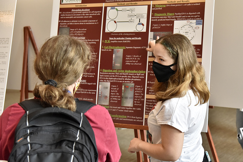 Biology student Kelsey Roberts talks about her research in “Molecular Cloning of Red Fluorescent Protein Tagged RalGDS,” during the Summer Scholarly and Creative Activities Symposium held in the Sheldon Hall ballroom