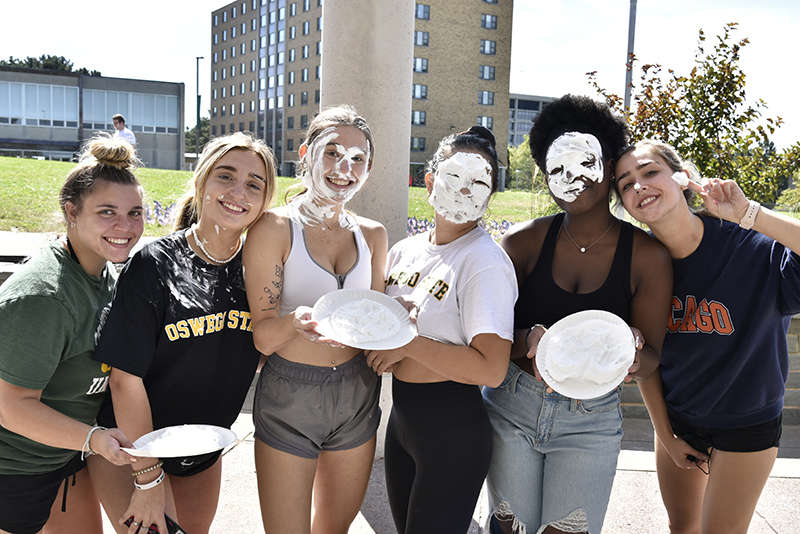 SUNY Oswego Cheerleading held a fun fundraiser Sept. 20 in which passersby could "pie" their faces in reward for a small donation. Team members outside Marano Campus Center are from left: Catherine Nocella, Isabela Garcia, Emily Cornell, Maya Agosti, Vivica Pierre and Jaclyn Pagliocca.