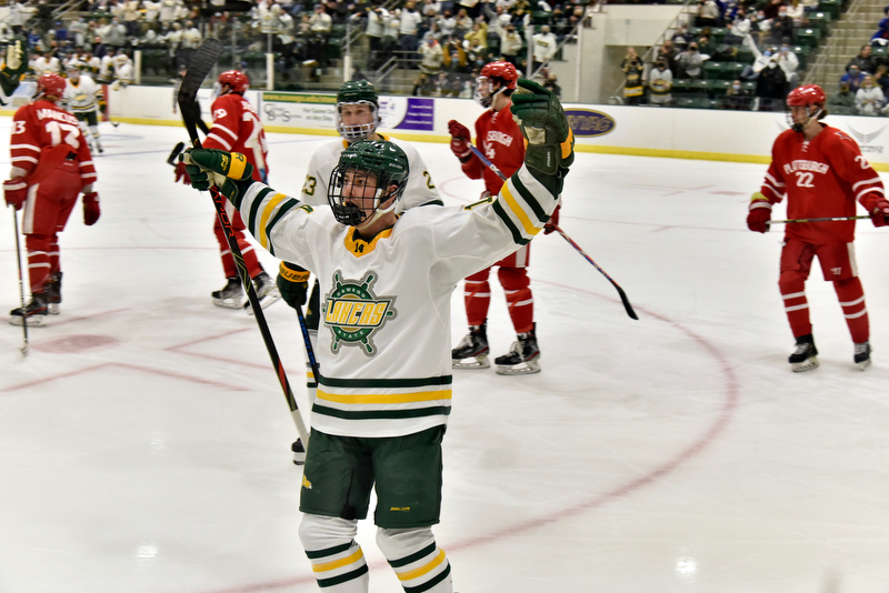 Pictured is Laker Conor Smart (#14) as he reacts to cheers from the fans and after making Oswego's fourth goal in second period action against Plattsburgh, as Oswego topped the Cardinals 5-2.