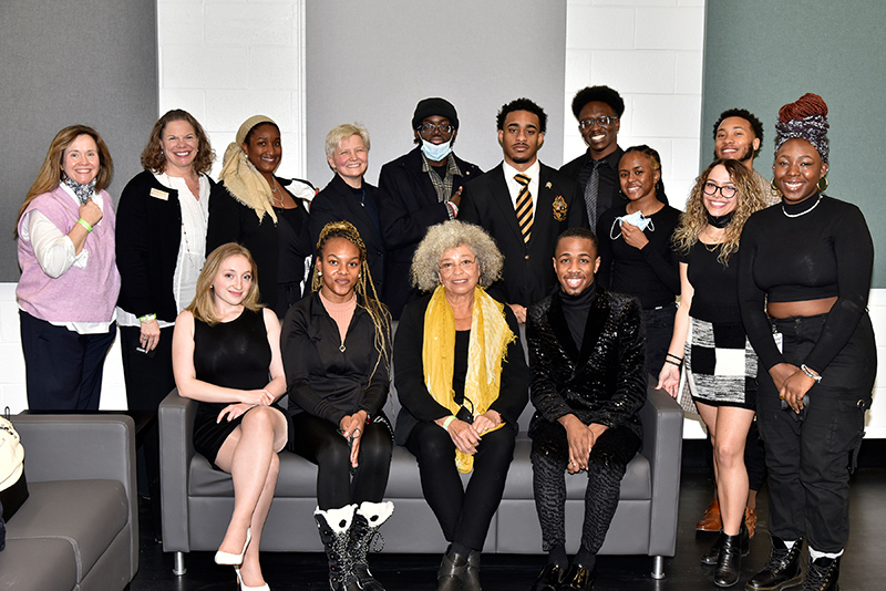 Oswego's 33rd annual Martin Luther King Jr. Celebration keynote speaker Angela Davis, seated center, gathers with students and campus leaders after the February event in Tyler Hall.