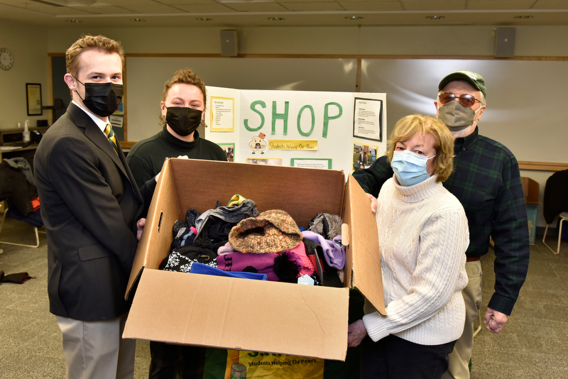 Sally and John Stroka, both alumni from the class of 1966, dropped off a large collection of items for the Winter Warm Up event that SHOP (Students Helping Oz Peers) hosted in 133 Marano Campus Center Feb. 15 through 17. At left accepting the donations is Helena Buttons, SHOP coordinator, and Jake Czaplicki, an intern with the Dean of Students Office.