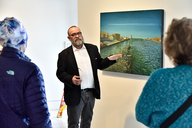 Artist Alberto Rey talks to an audience on March 4 about his work, "Biological Regionalism: Oswego River and Lake Ontario," exhibited in Tyler Art Gallery. The collection includes a series of large paintings, historical information, ecological research, large maps, video projections and an illustrated catalog, and combines science and art to create conversation about cultural, social, economic, technological and geopolitical issues related to local bodies of freshwater.