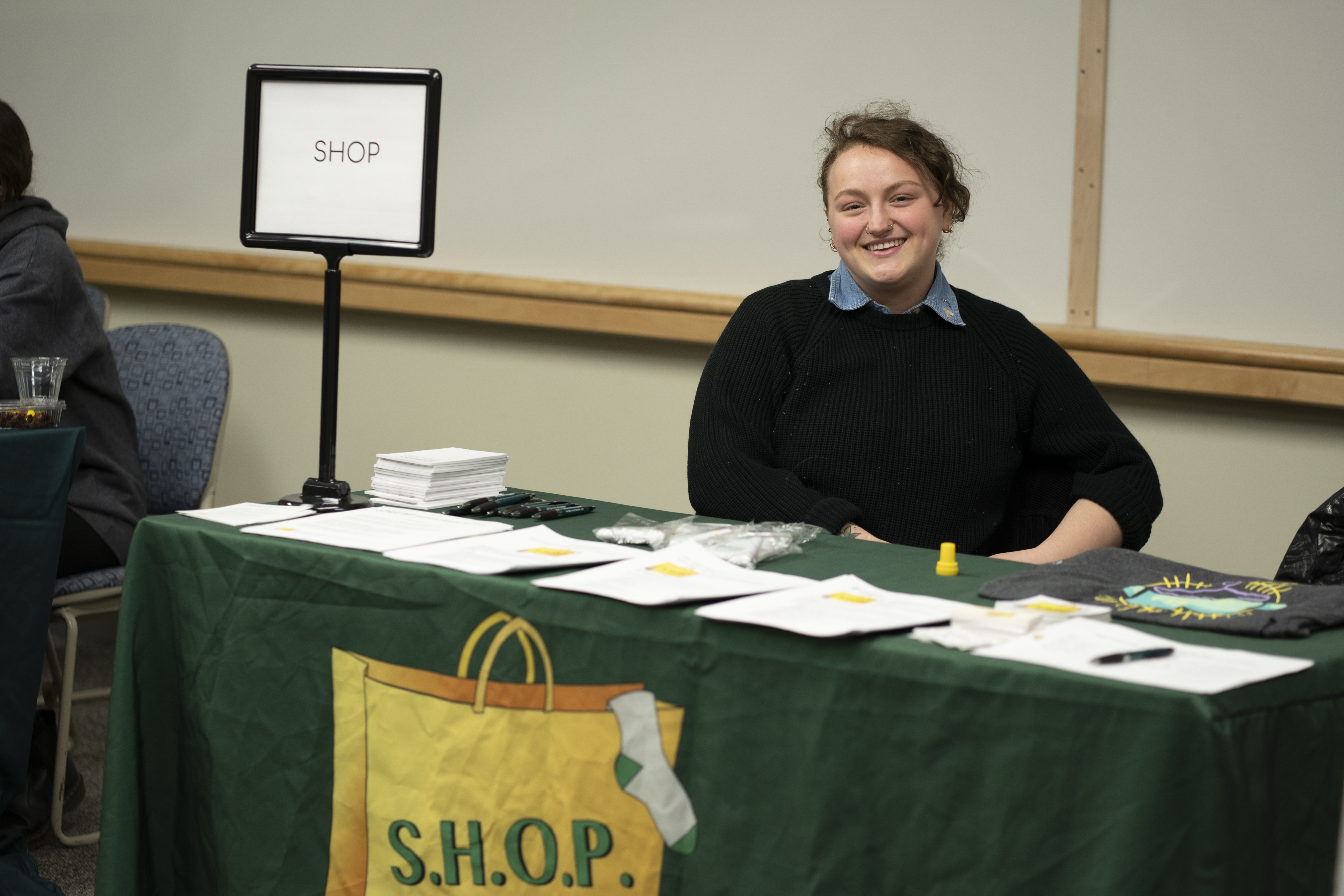 Dozens of campus offices and programs welcomed hundreds of students during the March 23 On-Campus Internship Expo in Marano Campus Center. Here SHOP (Students Helping Oz Peers) Coordinator Helena Buttons, a senior double major in communication and social interaction and in English, prepares to let potential interns know about the college’s on-campus pantry that provides food, clothing and other personal items to those in need.