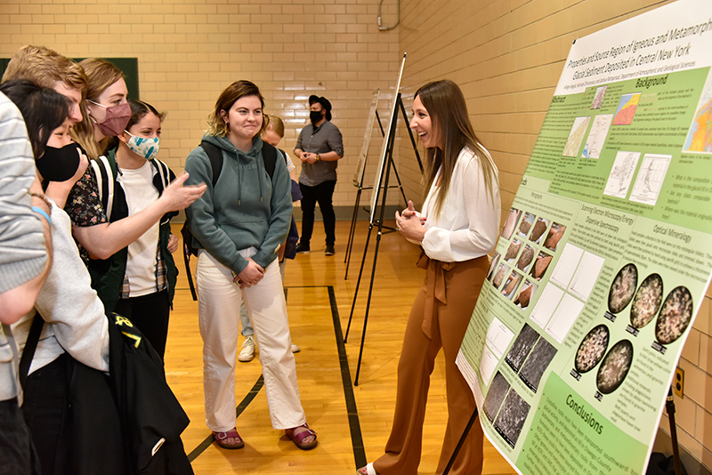 Allegra Neglia talks about her atmospheric and geological sciences study of "Properties and Source Region of Igneous and Metamorphic Glacial Sediment Deposition in Central NY" during the Quest poster session in Swetman Gymnasium.