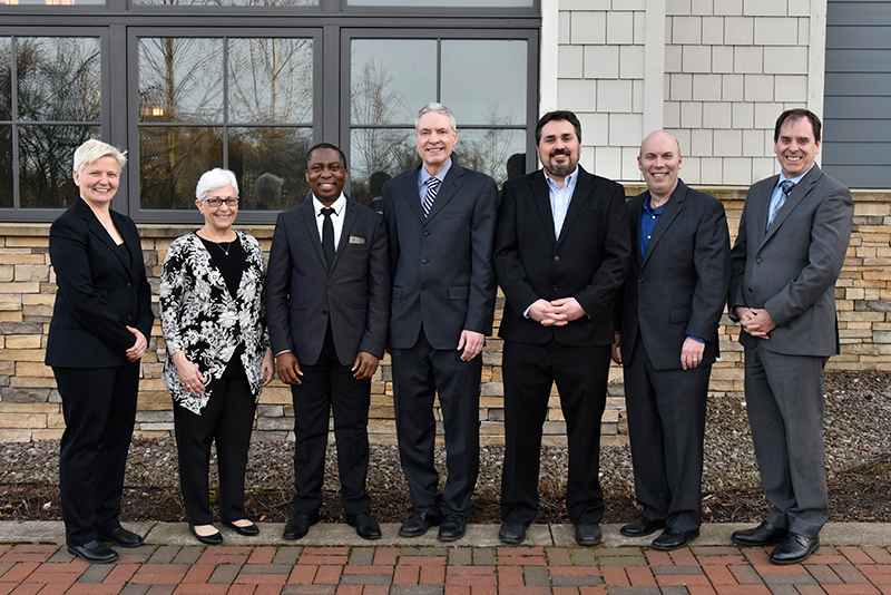 Several faculty members were recently promoted to full professor. SUNY Oswego Officer in Charge Mary Toale (left) and Provost and Vice President for Academic Affairs Scott Furlong (at right), mark the occasion in congratulating, from left: Joanne O'Toole, Benjamin Ogwo, Richard Skolnik, Matthew Dykas and Scott Steiger. Missing from the photo are Kelly Roe, Cara Thompson and Lisa Glidden.
