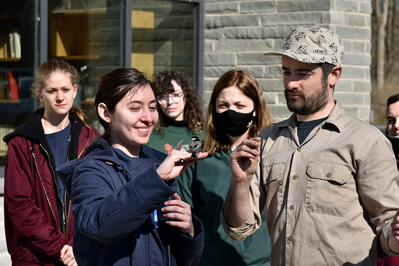 Students in biological sciences faculty member Daniel Baldassarre's ornithology class met at Rice Creek Field Station for more hands-on experience with a variety of bird species. Callista Weber, pictured, holds a black-capped chickadee before releasing it back into the habitat.