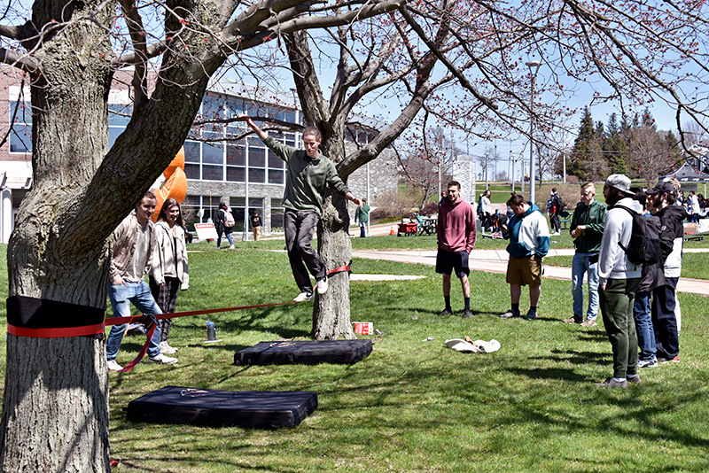 The Outdoors Club offered the chance to try tightrope walking during the Earth Day celebration. John Custodio, pictured, shows his balance and skill as other Earth Day events were in full swing nearby.