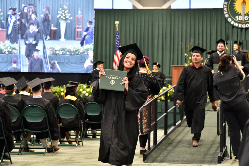Graduates at the 12:30 p.m. School of Business Commencement make the happy walk for recognition of their degrees.