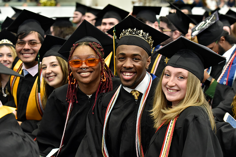Graduates smile during the 4 p.m. School of Communication, Media and the Arts; and School of Education commencement ceremony.