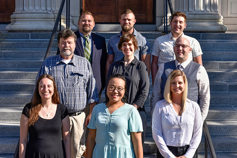 New tenure-track faculty members at New Faculty and Professional Staff Orientation on Sheldon Hall steps at SUNY Oswego