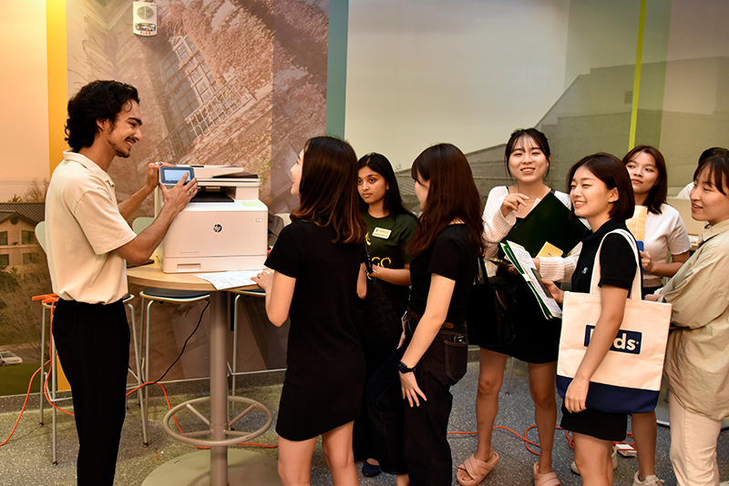 SUNY Oswego student Kaushal Joshi meets with international students at orientation on August 19 to assist with scanning documents and answer international student questions.