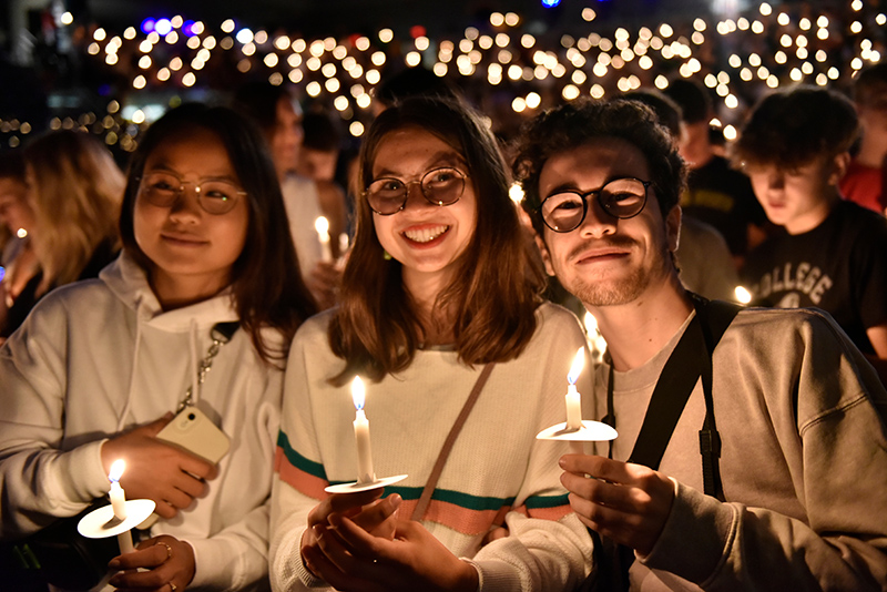Students proudly hold their candles during the Welcoming Torchlight Ceremony Aug. 19.