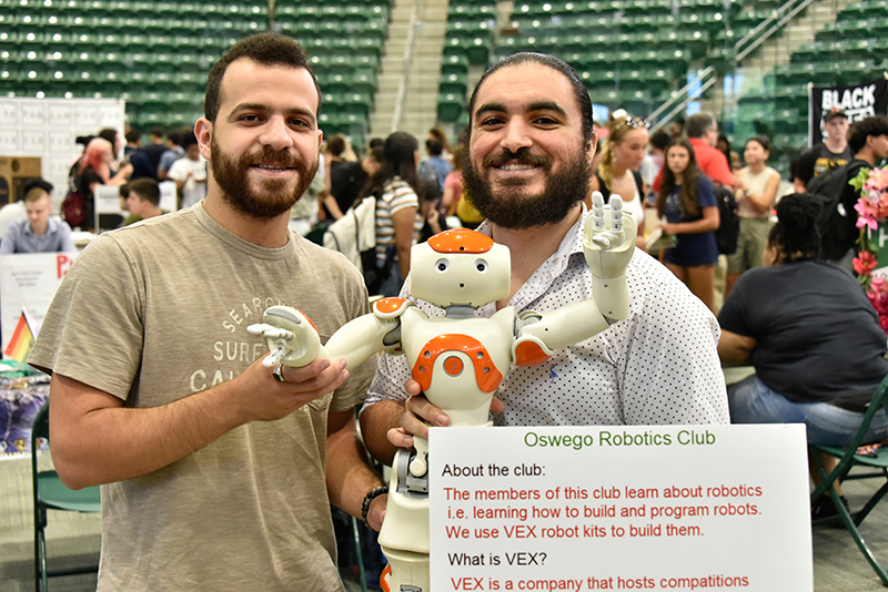 Robotics Club members pose with robot at Student Involvement Fair 