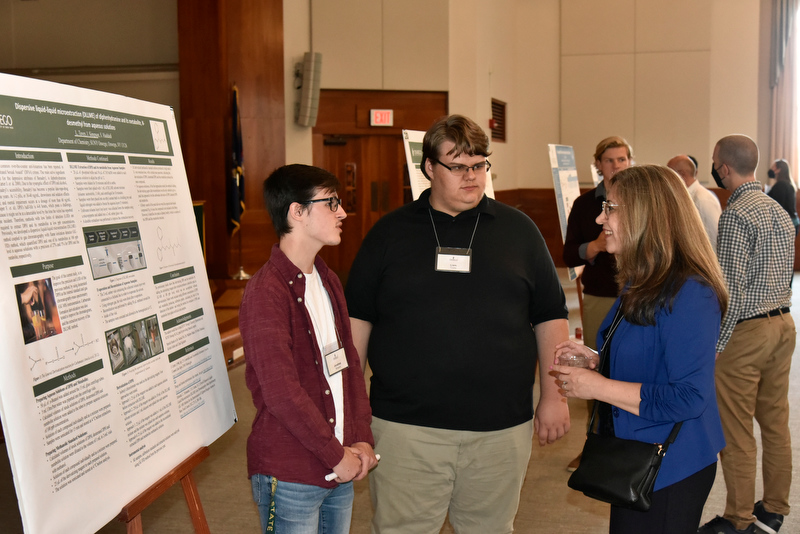 Pictured from left, Jonathan Simpson and Liam Tovey talk with their faculty mentor Shokouh Haddadi of the chemistry department about their work, “Dispersive liquid-liquid micro-extraction of diphenhydramine and its metabolite, N-desmethyl from aqueous solutions.”