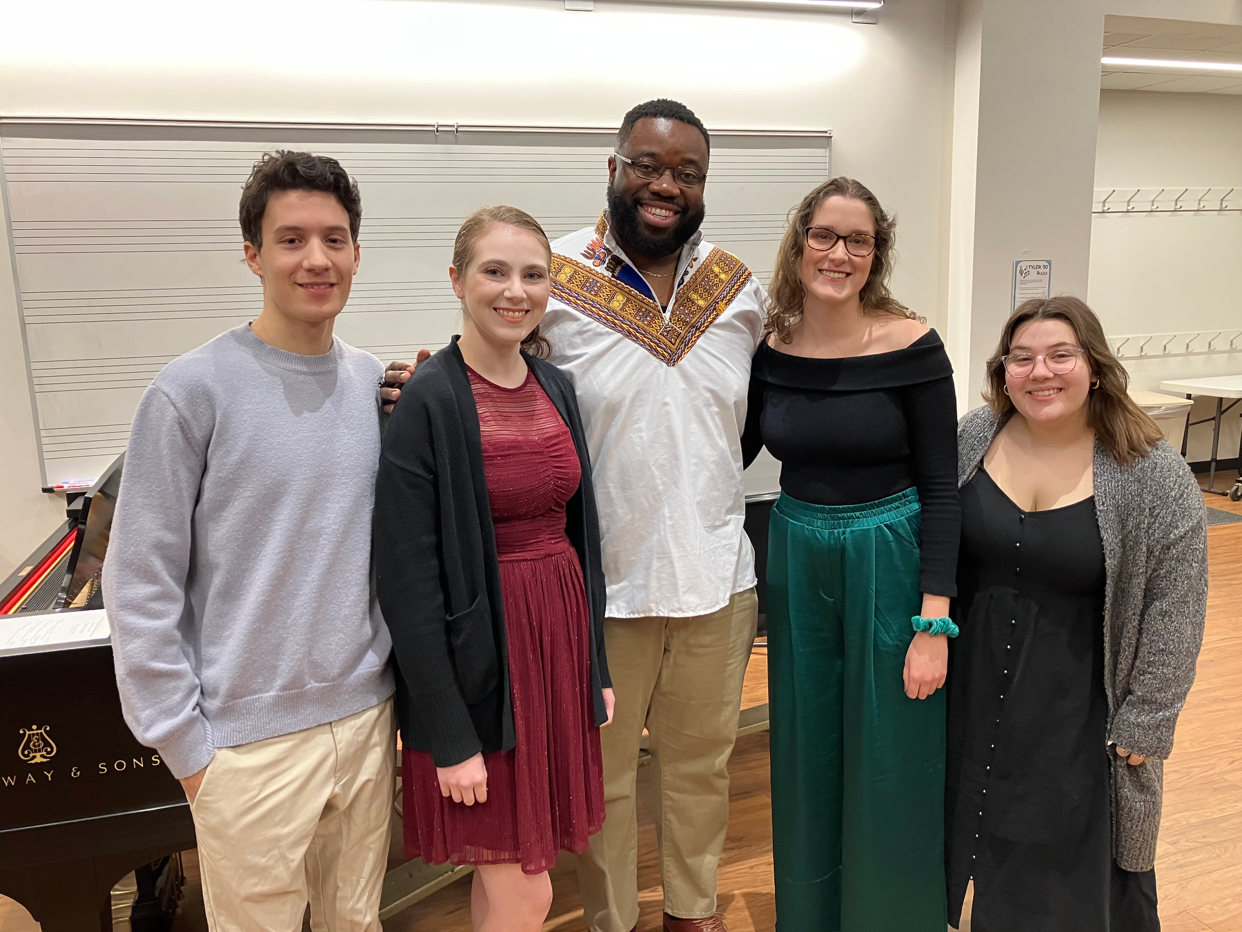Tamar Greene (center), a 2009 SUNY Oswego alumnus who appears on Broadway as George Washington in the mega-hit musical “Hamilton,” provided feedback to student vocalists in a master class on Tuesday, Nov. 29. The singers he gave praise pointers to are, from left. Hunter Caiazzo, Mackenzie Shields, Molly DeMarco and Olivia Cibella.