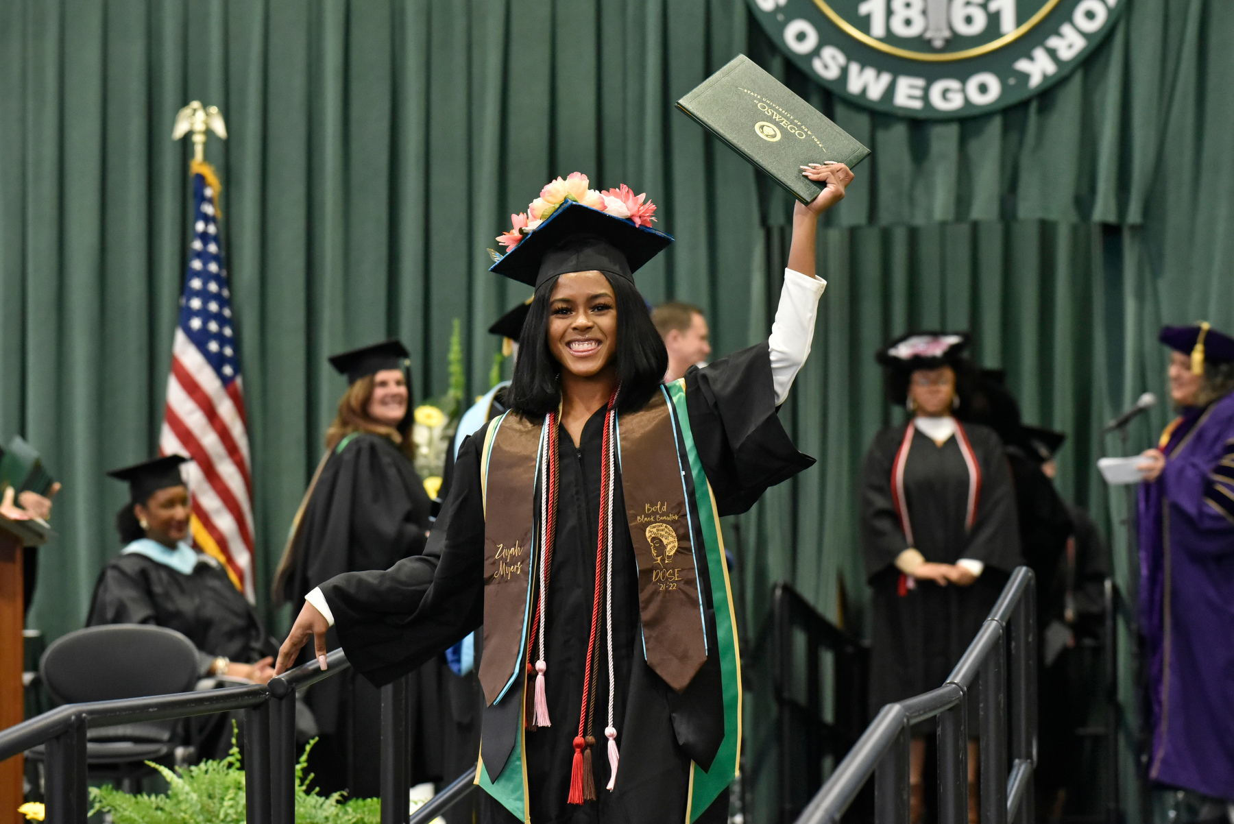 Ziyah Myers, a graduate from the School of Communication, Media and the Arts, shows her pride as she receives recognition on the platform during the December Commencement ceremony held Dec. 10 in the Deborah F. Stanley Arena and Convocation Hall.