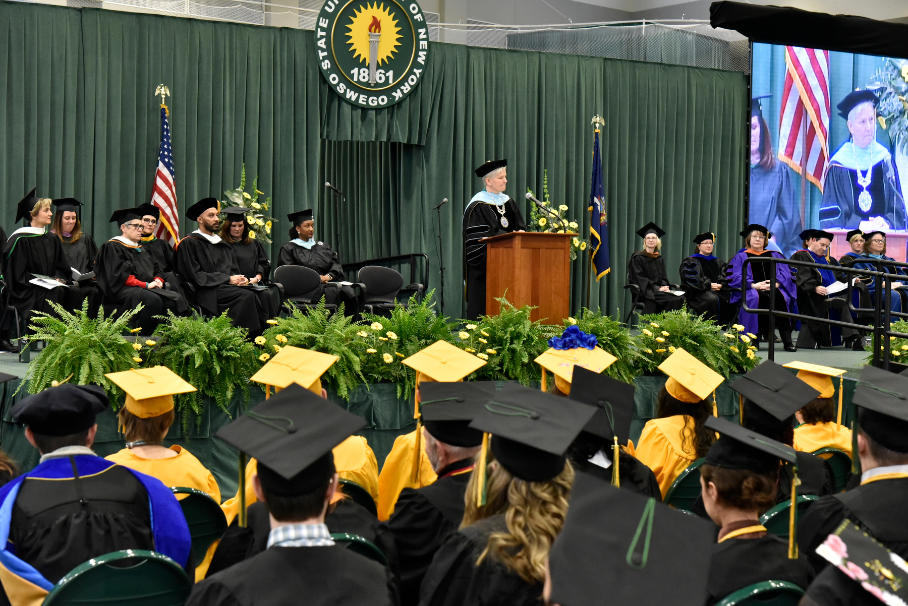Mary C. Toale, SUNY Oswego's Officer in Charge, provides the Charge to the Graduates while speaking to the graduates and their families during the December Commencement, Dec. 10 in the Deborah F. Stanley Arena and Convocation Hall.