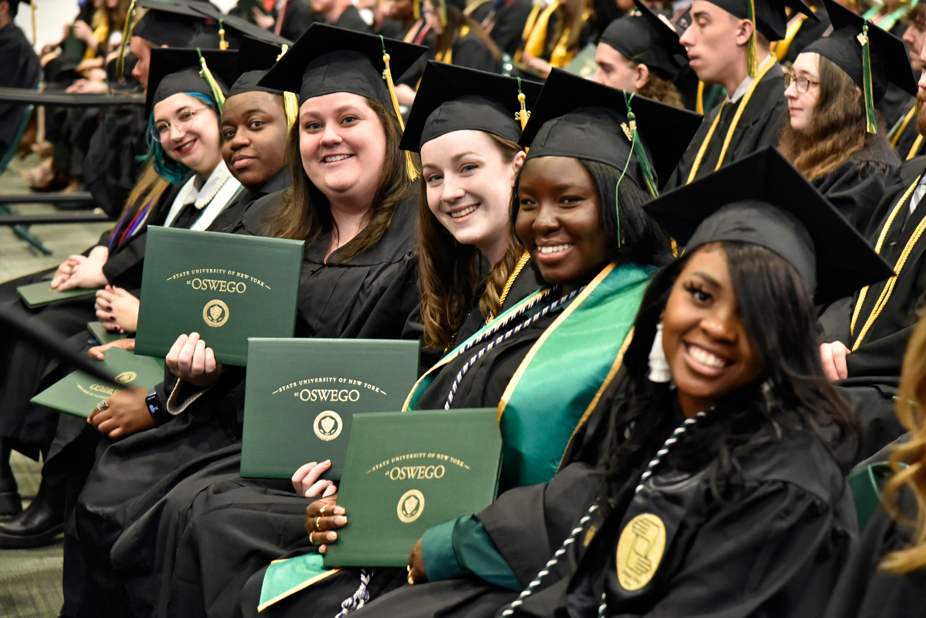 Showing their pride are graduates from the College of Liberal Arts and Sciences, from left, Gabrielle Sennert, Caleb Whyte, Alyson McDonough, Kimberly Reilly, Brittany Ferguson and Lidsai Jammy Jean Baptiste.